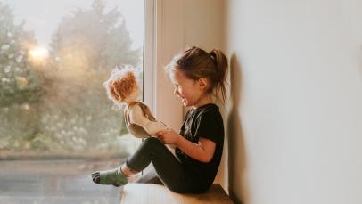 Girl playing cheap with dolls